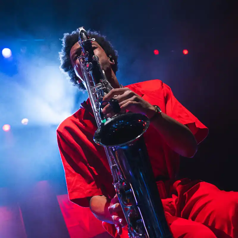 A Saxophonist in a striking red retro uniform with the New Wave Orchestra at Balboa Theatre in San Diego