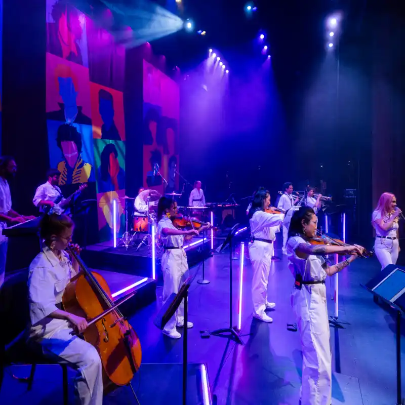 The string section of the New Wave Orchestra on stage at Balboa Theatre in San Diego
